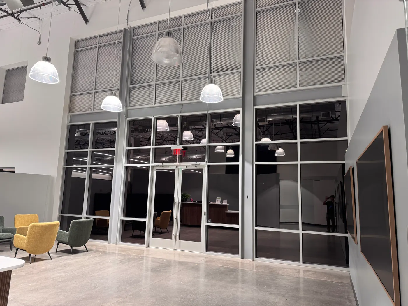 Tinted glass office partitions and entry glazing in a commercial building, installed by ACR Film Solutions