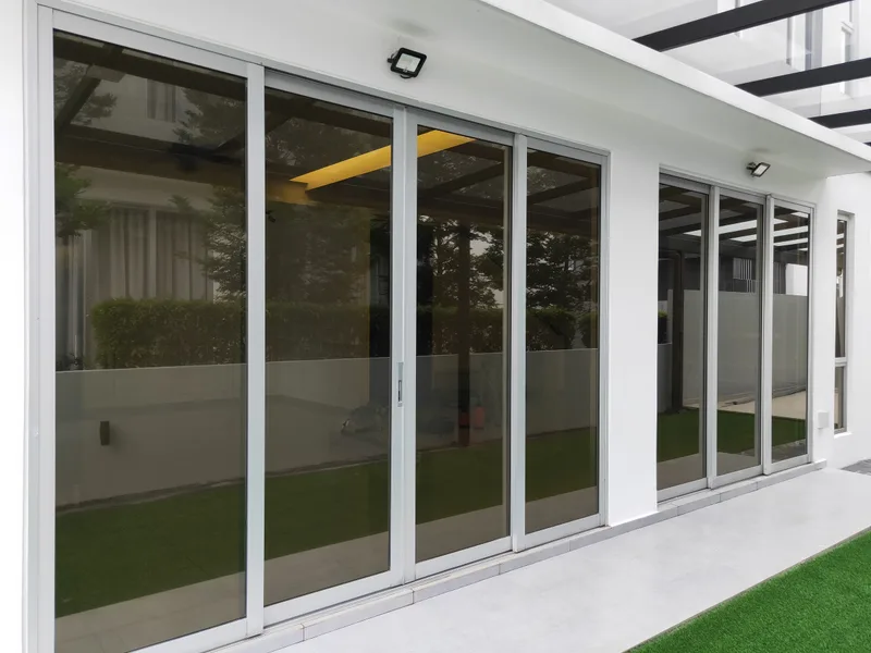 Sliding glass patio doors with window film and a frosted privacy band